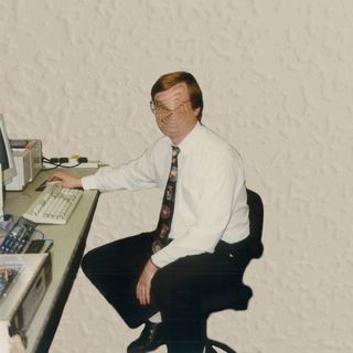 A human sitting on a chair, their face is imploding on itself